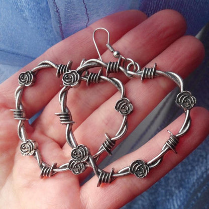 Barbed Wire Heart Gothic Earrings - Edgy silver earrings featuring a heart shape wrapped in barbed wire design, perfect for gothic fashion enthusiasts.